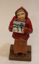 A wood carved portrait figurine of Nova Scotia folk artist Maud Lewis.